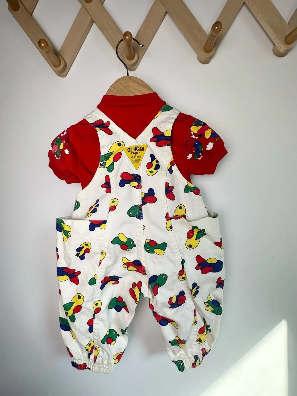 OshKosh B'gosh White Overalls with Colorful Airplane Print and Red Accents